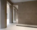 Colonnato moderno con pareti e pilastri in intonaco o stucco color sabbia, illuminato da luce soffusa.