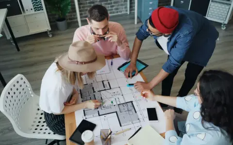 Team discute progetto edilizio, pianificando il pagamento stato avanzamento lavori privati.