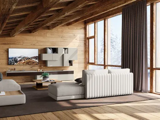 Accogliente soggiorno con travi in legno a vista, mobili chiari e vista innevata. I colori delle case di campagna si riflettono nell'arredo.