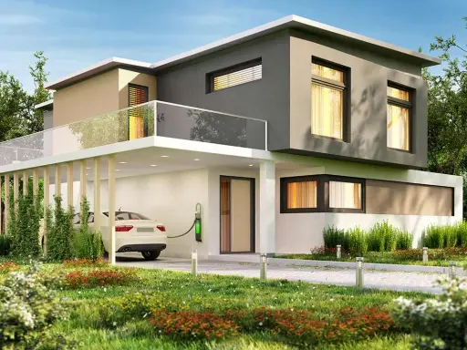 Casa moderna con tetto piano, balcone in vetro e un'auto bianca in carica. Il colore esterno casa verde si integra con il giardino lussureggiante.