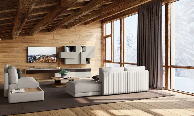 Accogliente soggiorno con travi in legno a vista, mobili chiari e vista innevata. I colori delle case di campagna si riflettono nell'arredo.