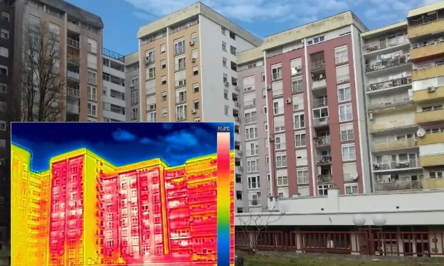 Termografia di palazzi residenziali che evidenzia la trasmittanza termica periodica, con aree rosse e gialle che indicano dispersioni di calore.